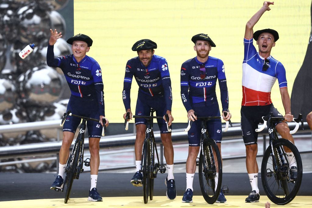 Groupama FDJs French rider David Gaudu R and teammates toss water bottles to spectators from the stage during the official teams presentation near the Guggenheim Museum Bilbao in Bilbao northern Spain on June 29 2023 two days prior to the start of the 110th edition of the Tour de France cycling race Photo by AnneChristine POUJOULAT AFP Photo by ANNECHRISTINE POUJOULATAFP via Getty Images