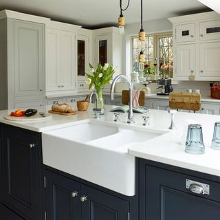 kitchen with white and black cabinet and white washbasin