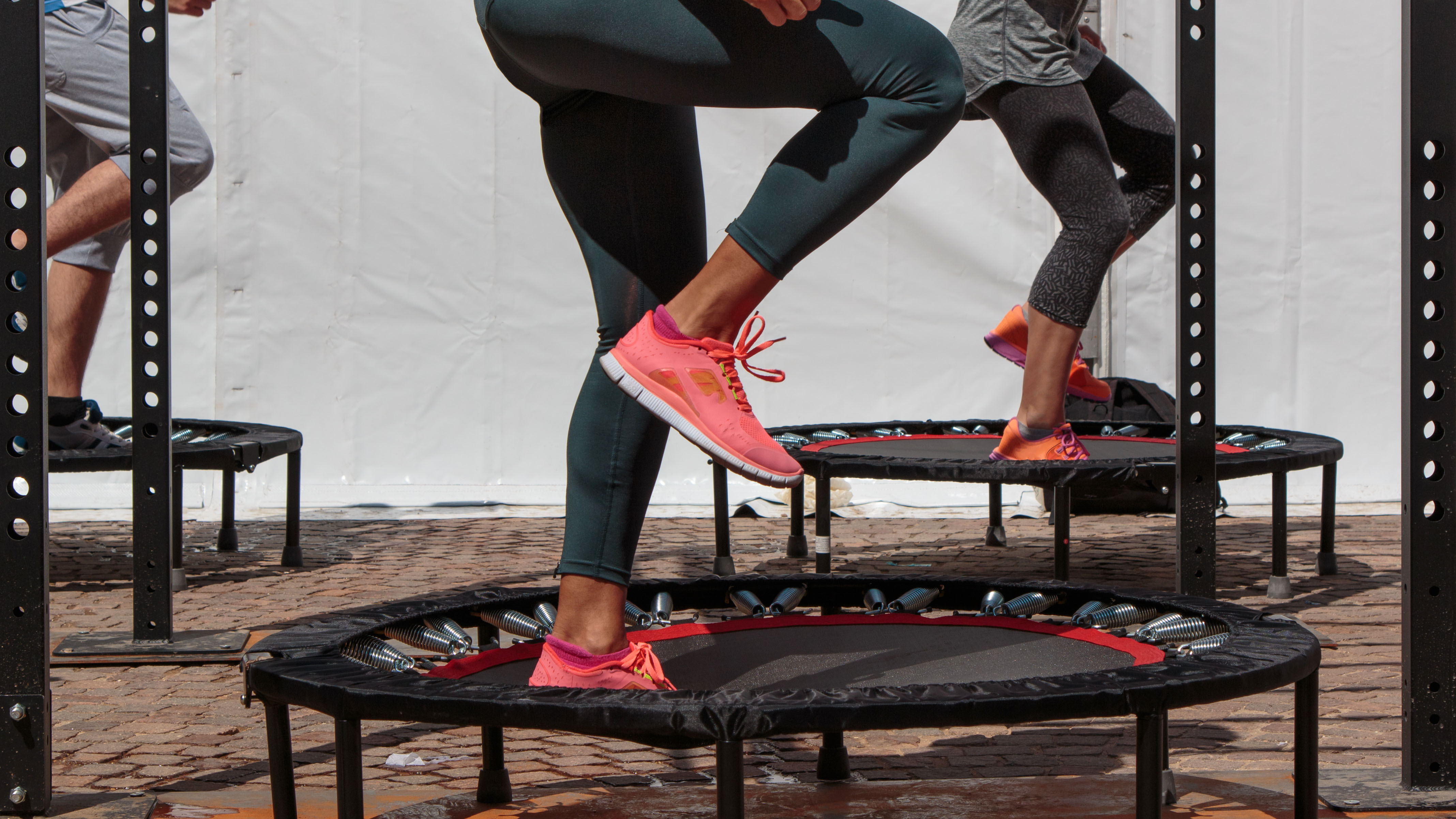 a photo of a woman jumping on a mini trampoline 