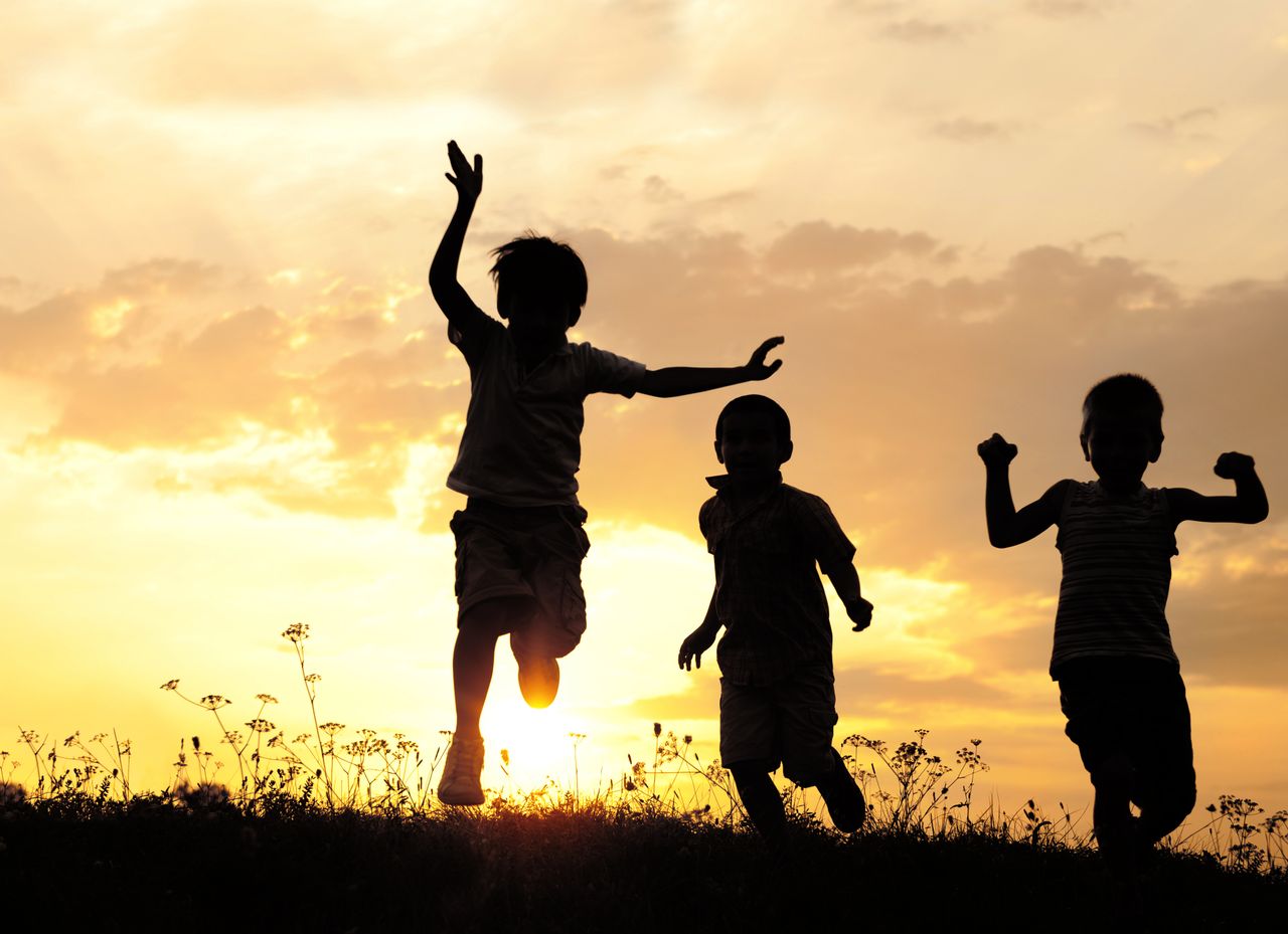 Kids play as the sun sets