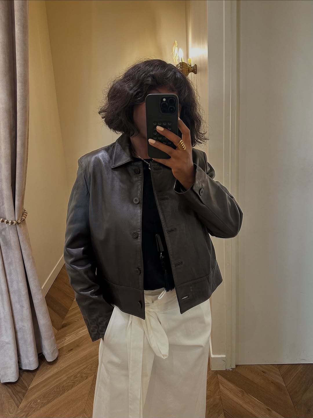 Woman wearing collared leather jacket trend fall 2025.