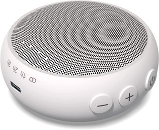 A white circular speaker for sleep sounds