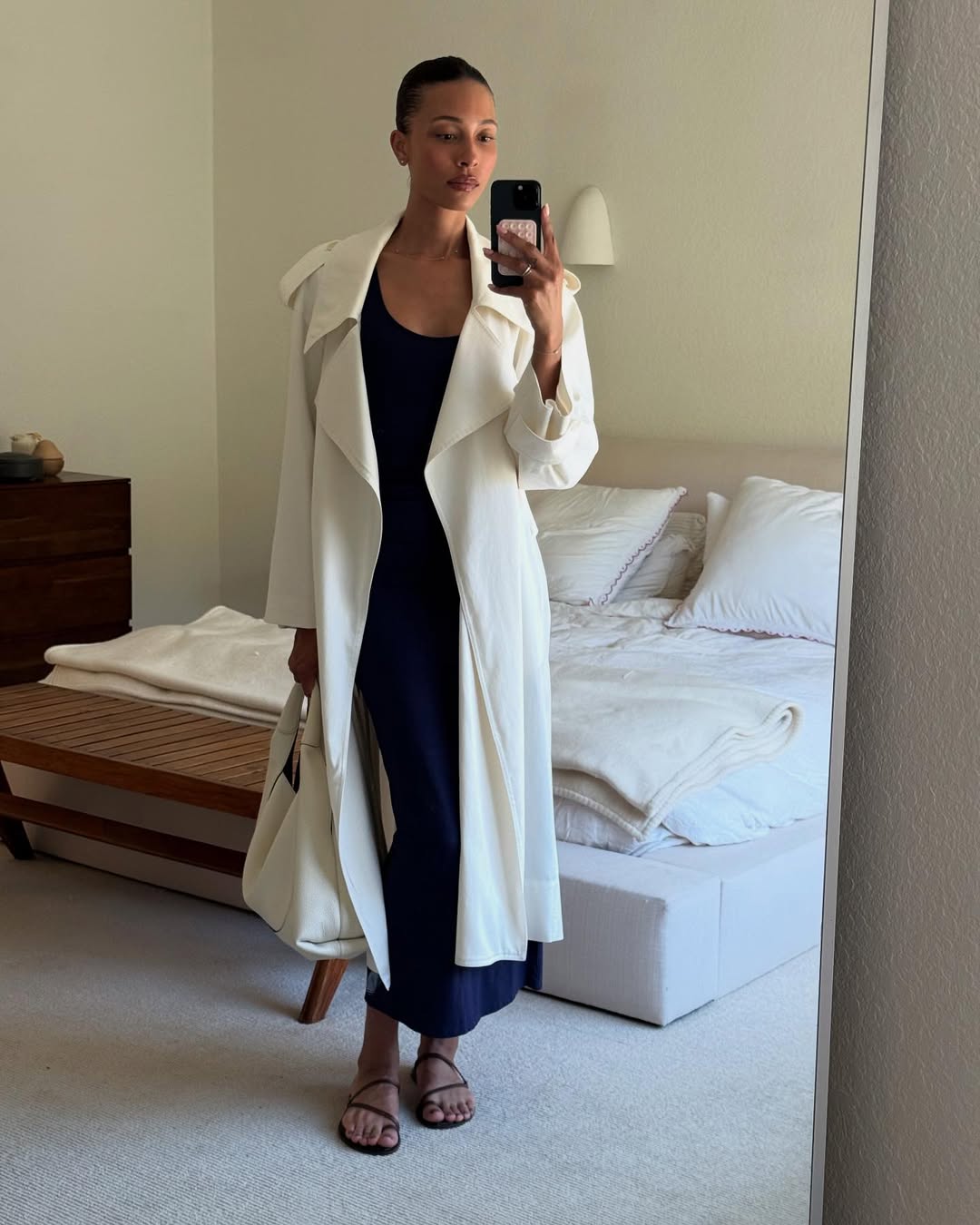influencer outfit photo featuring a white handbag