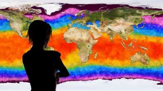 A 3D illustration of a woman watching a climate change simulation of Earth.