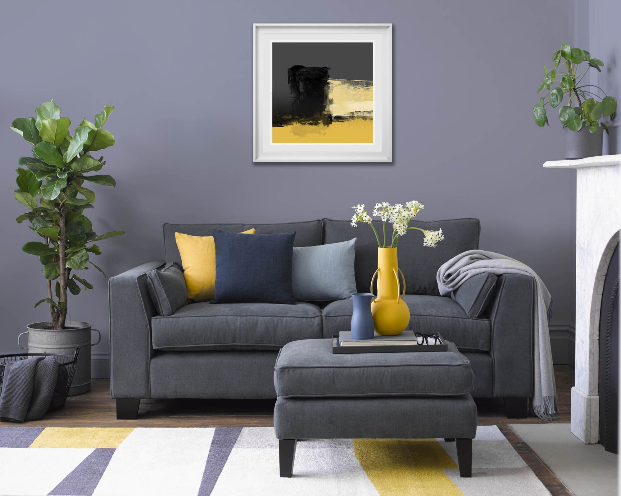 A grey sofa with yellow cushions and mauve wall in a living room