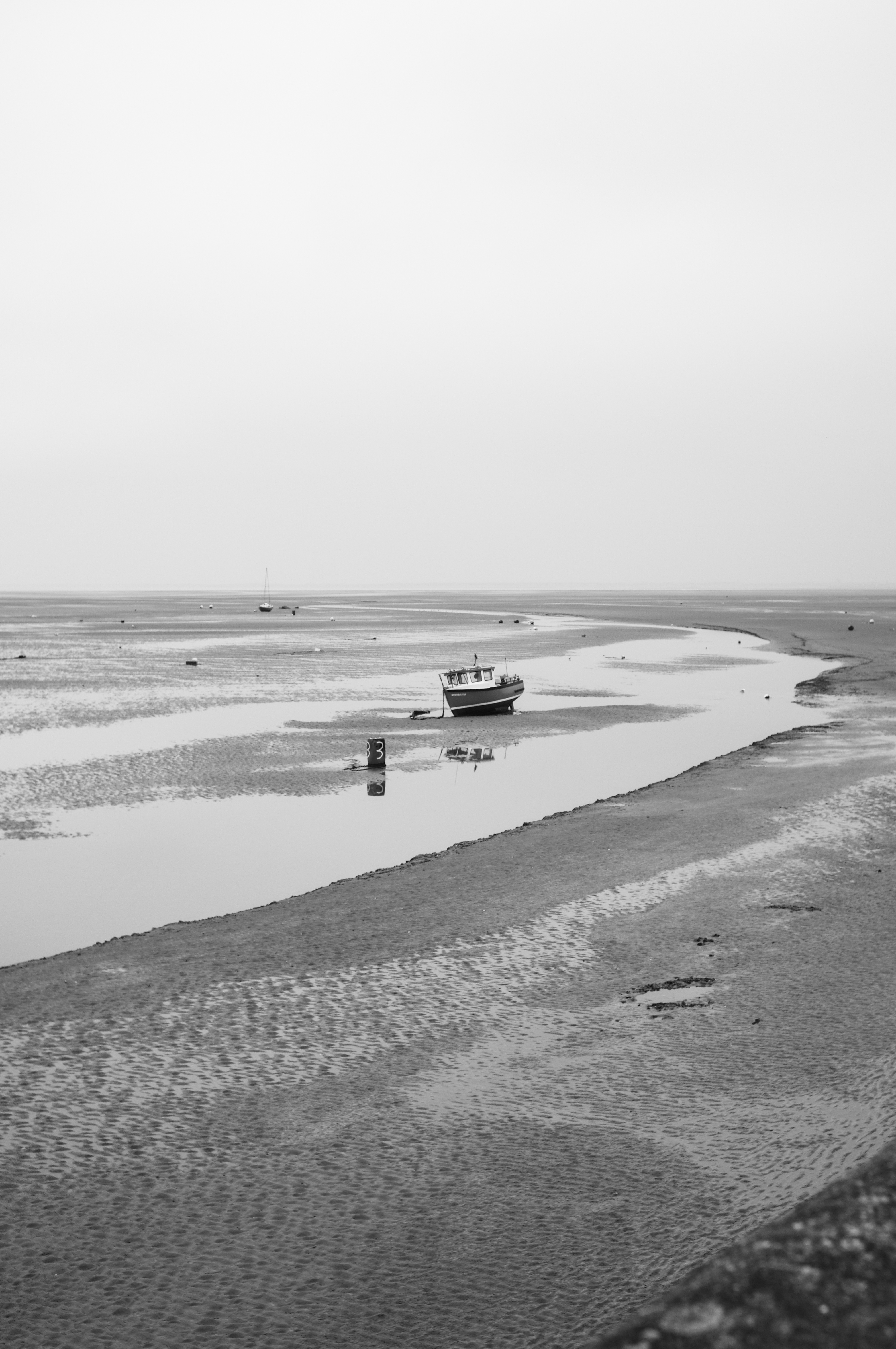 Boats grounded on the beach with the tide out