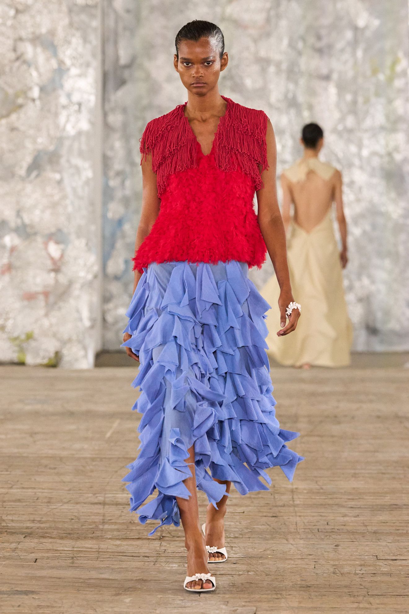 A woman walks down the runway in an unexpected color combination