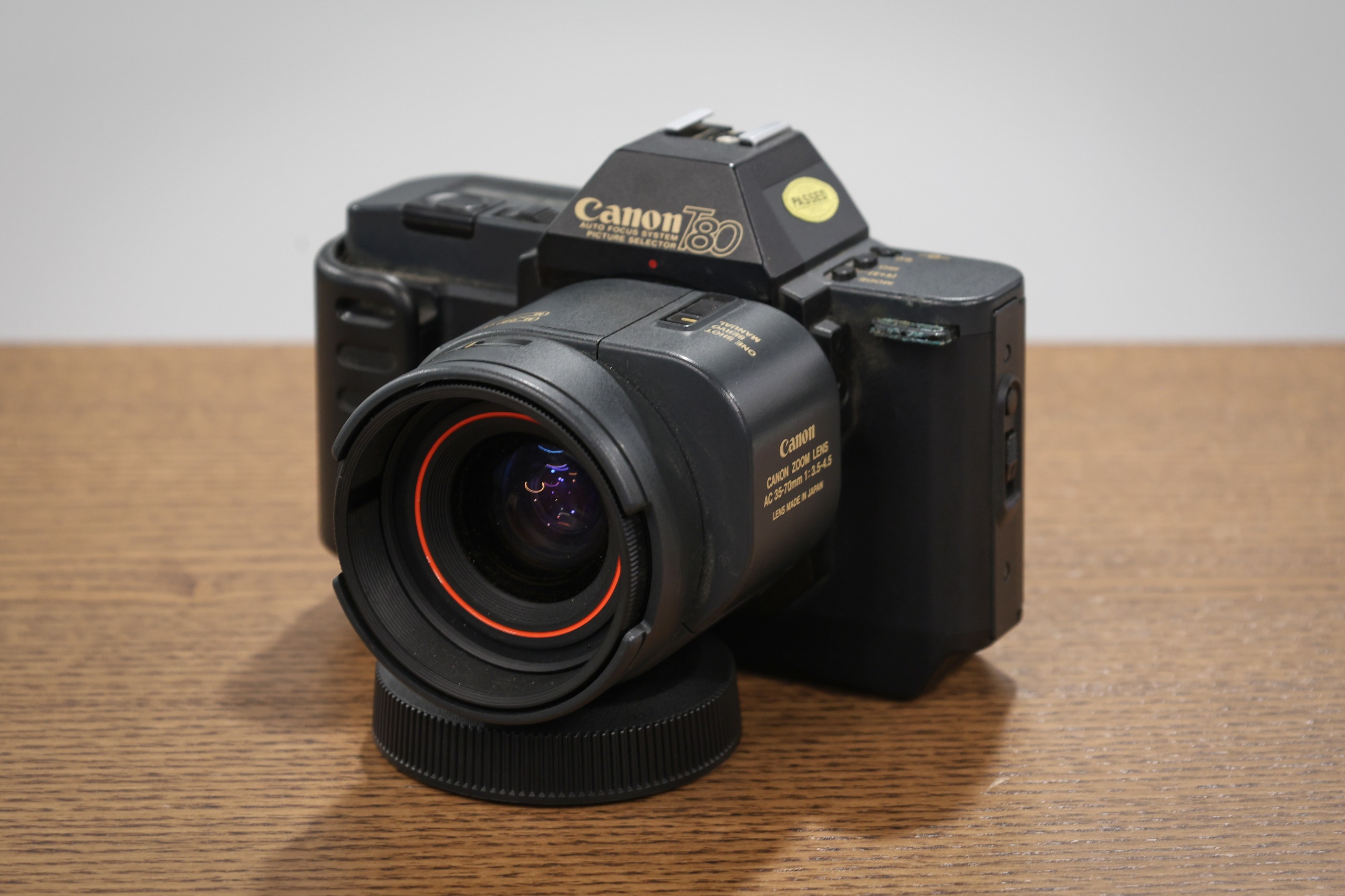 Canon T80 with Canon AC 35-70mm f/3.5-4.5 lens, on a wooden table, taken on the Canon EOS R8 Mark II with the Canon RF 24-105mm f/4-7.1 IS STM