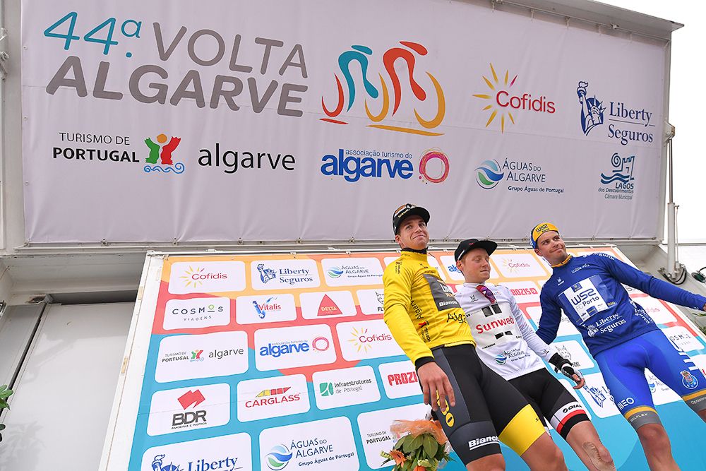 Dylan Groenewegen in the Volta ao Algarvey yellow jersey, Sam Oomen in the white jersey of the best young rider and Joao Rodriguez in the blue mountain jersey