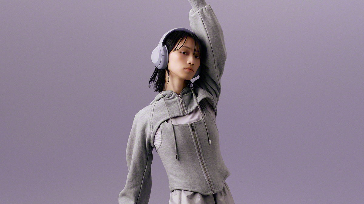 Sony headphones in lavender, worn by a woman also dressed in lilac/lavender