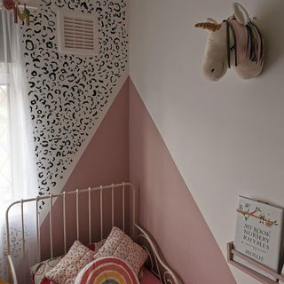 bedroom with white and pink wall and celery painting on wall