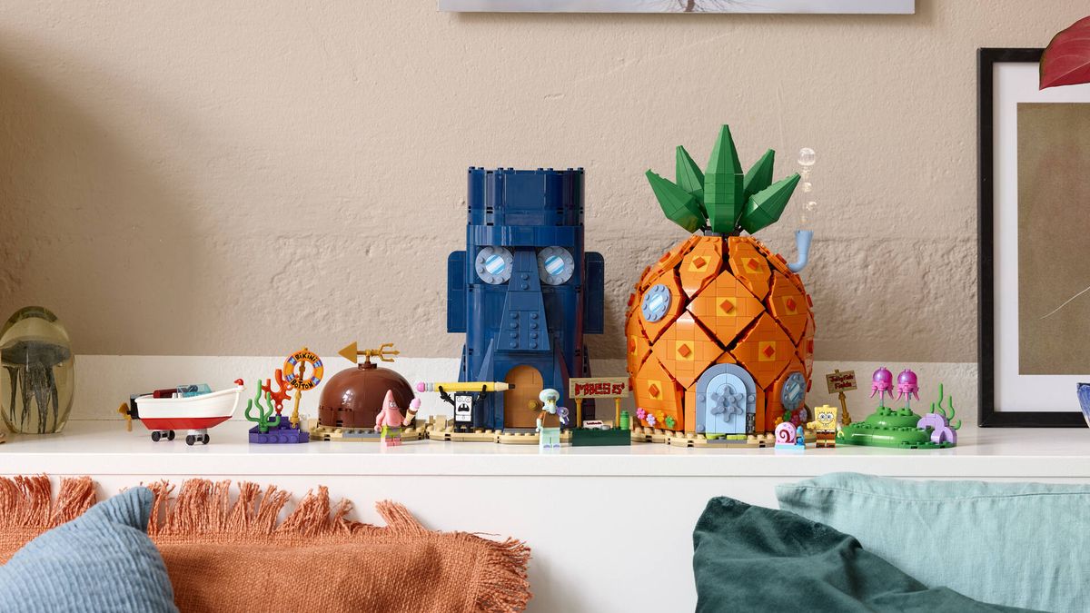 The Lego Bikini Bottom set laid out in a row on a white shelf behind cushions