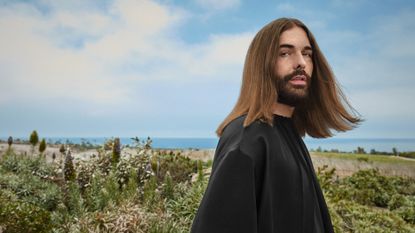 jonathan van ness with good hair in a field