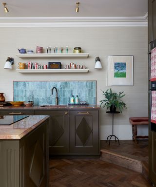 kitchen with green cabinetry and teal tiles