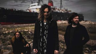 Oli Brown & The Dead Collective standing by the sea