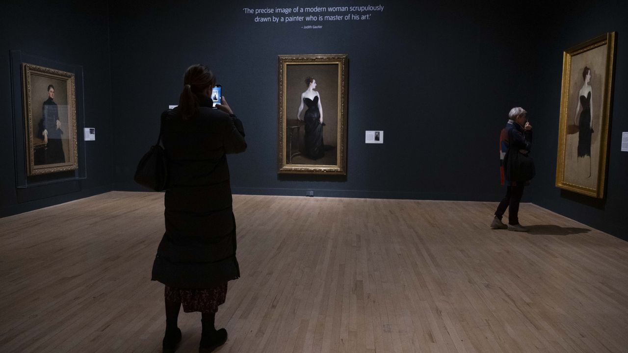 A visitor observes the &quot;Sargent and Fashion&quot; exhibition at Tate Britain