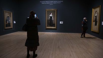 A visitor observes the "Sargent and Fashion" exhibition at Tate Britain