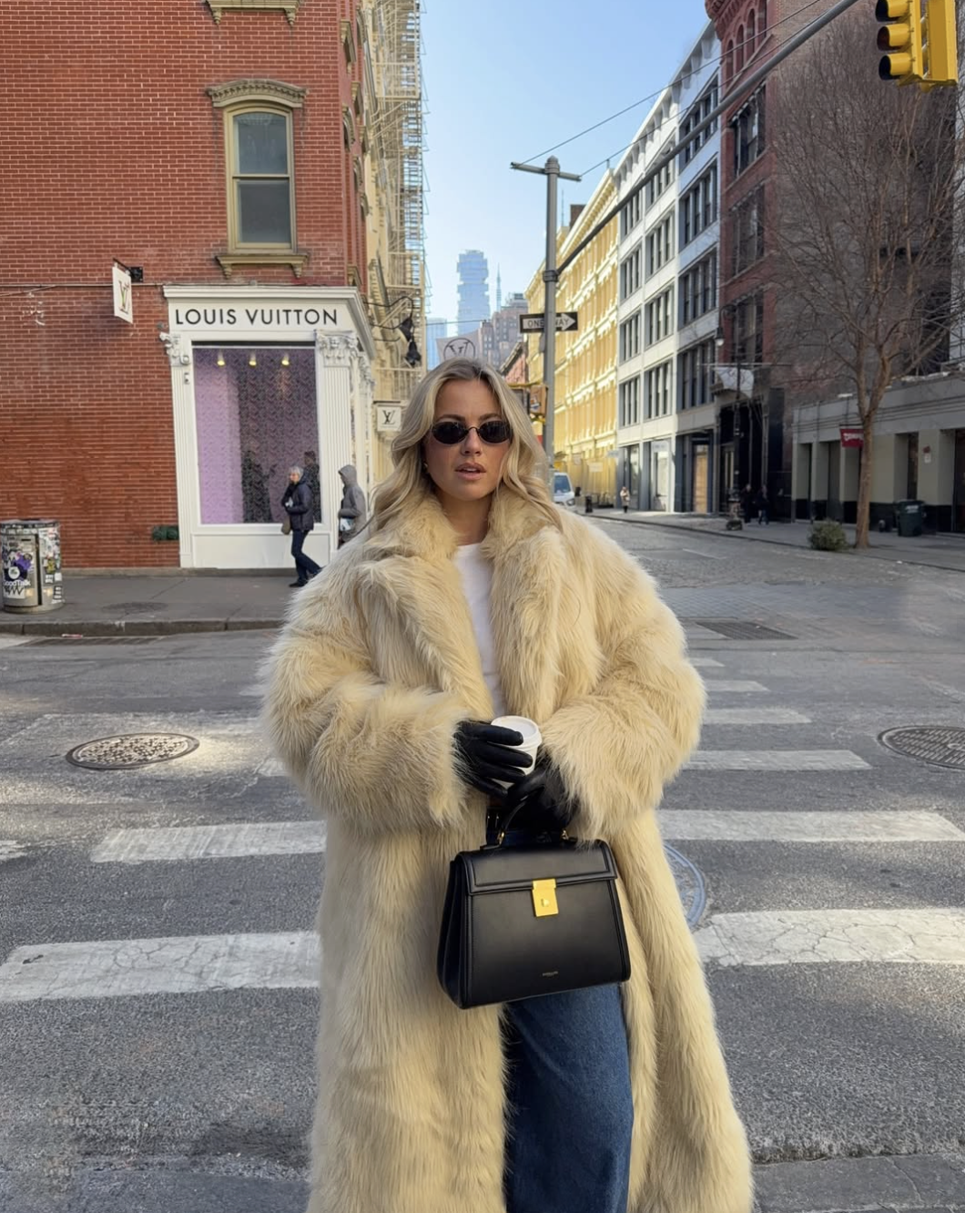woman in fur coat and jeans