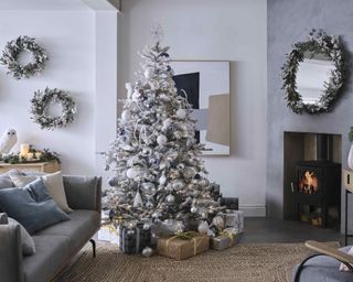 Christmas tree ideas with a frosted artificial tree and white and silver decorations