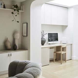 Open plan living room with built-in desk as a home office.