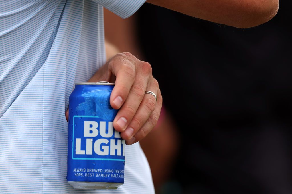 A picture of a man holding a can of Bud Light