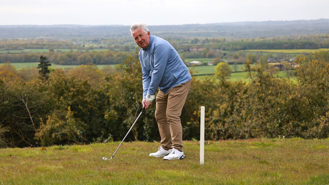 Golfer near out of bounds stake