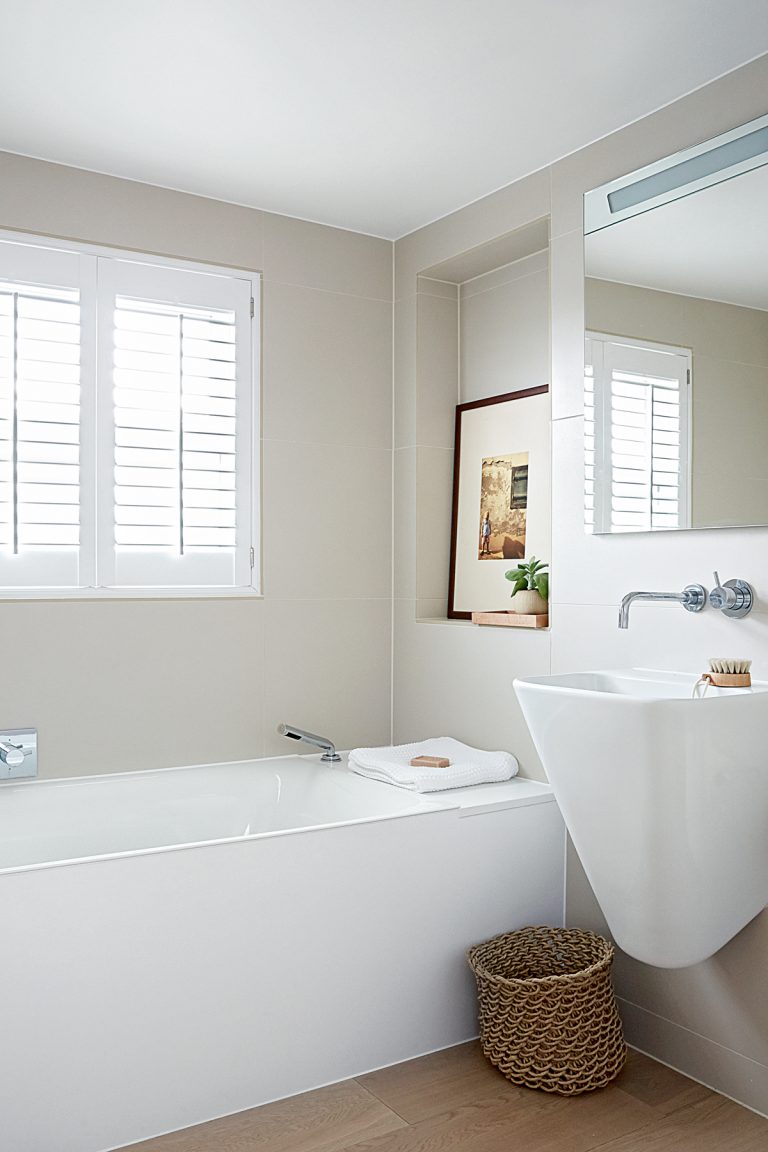 small white bathroom with floating sink