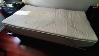Saatva Foam Mattress Topper on top of a platform bed