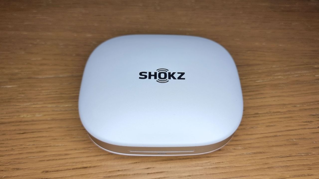A closed charging case for the Shokz OpenFit Pro earbuds