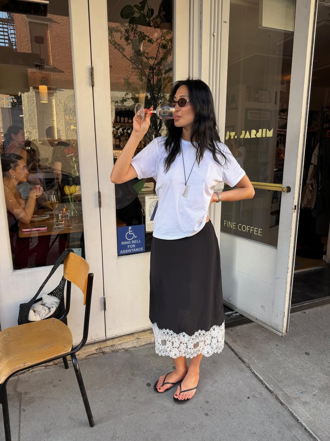 Laura Jung wearing a pendant necklace with a boxy T-shirt and lace-trim skirt.