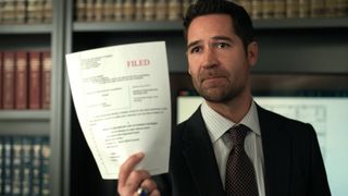 Micky Haller (Manuel Garcia-Rulfo) holding a legal document as seen in "The Lincoln Lawyer" season 3