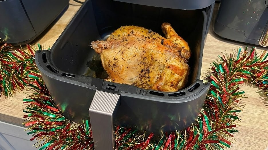 Roast chicken in air fryer, with tinsel on kitchen counter