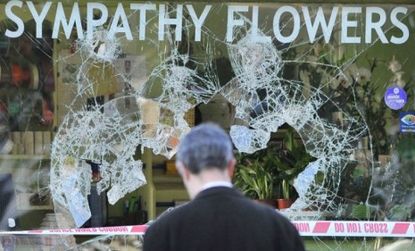 A man looks into a looted flower shop in west London.