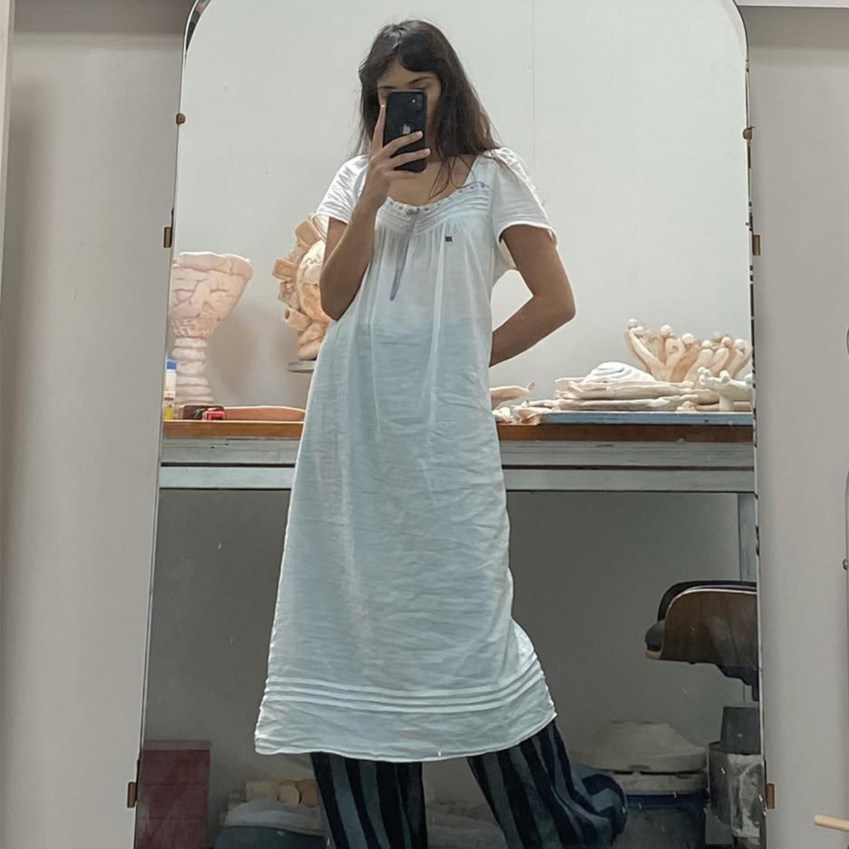 Seala Lokollo wearing a white dress. 