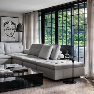 grey living room ideas, grey living room with L shaped sofa, black crittall doors and accents