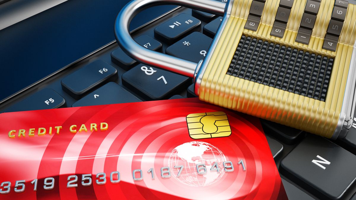 Credit card and padlock standing on laptop computer. 