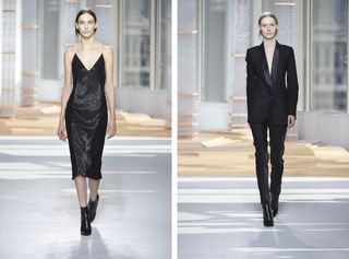 2 female models on a runway, one wearing a black suit and one wearing a black dress