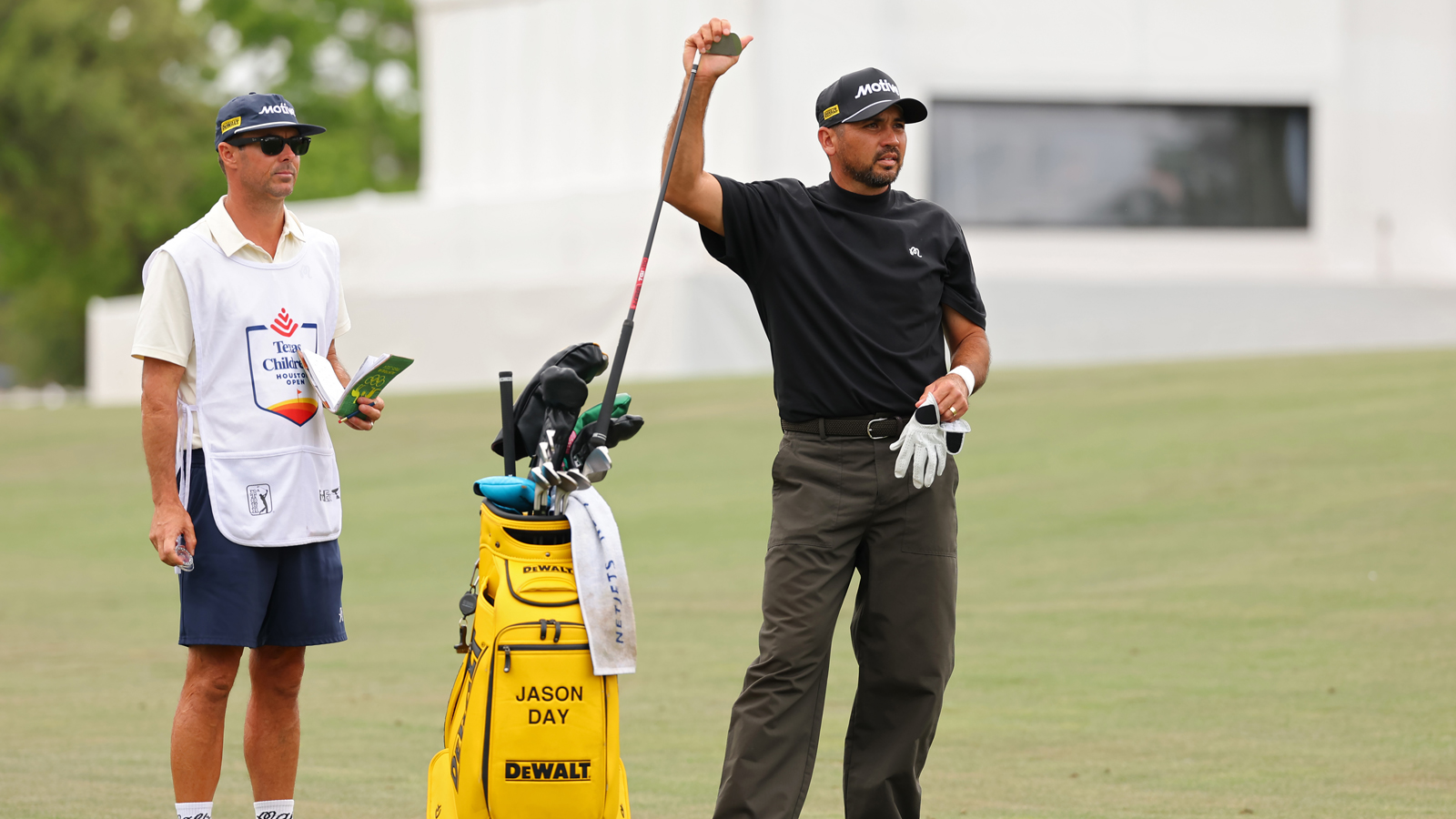 Jason Day pulls a golf club out of his bag