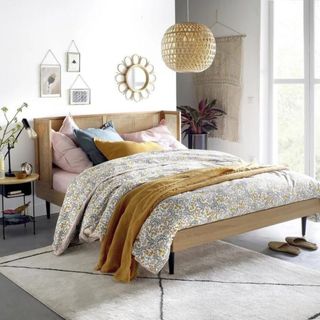 Rattan bed frame in white bedroom