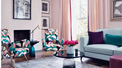 Pink living room with curtains and contrasting armchairs
