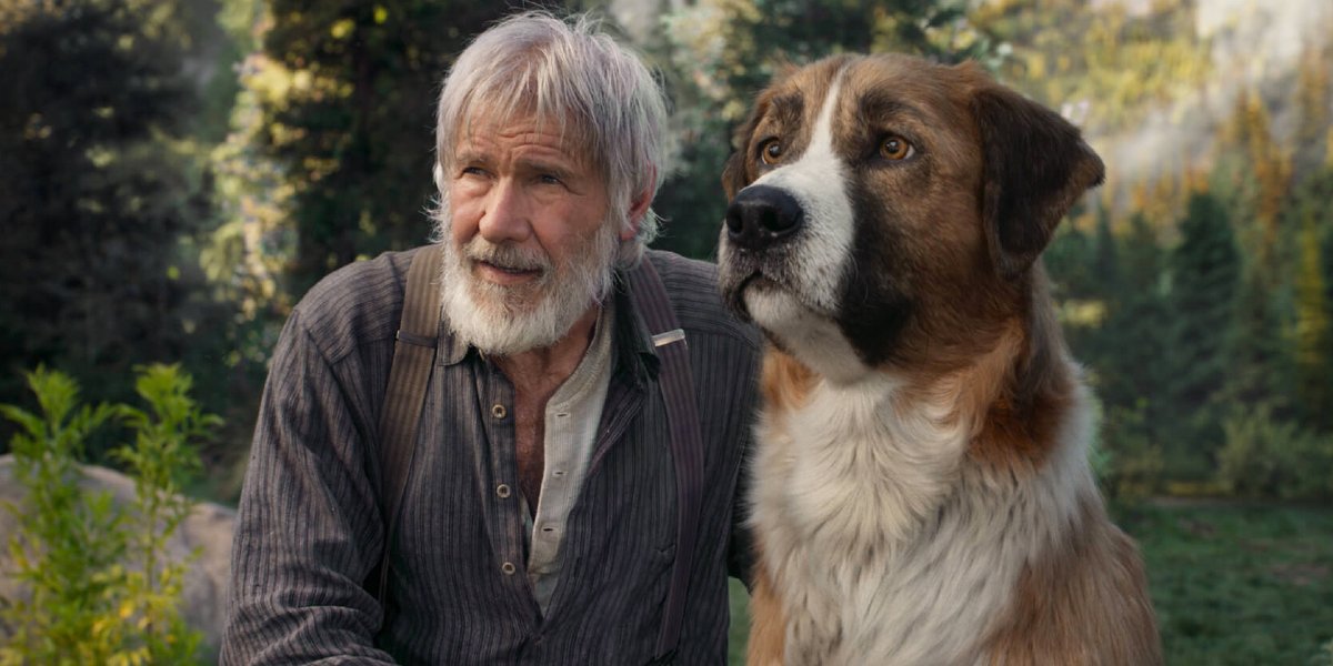 The Call of the Wild Harrison Ford sits next to Buck in the wild