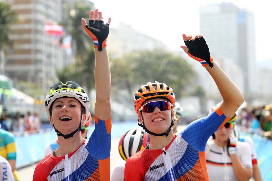 Annemiek van Vleuten and Ellen van Dijk wave to the crowd at the start of the women's road race