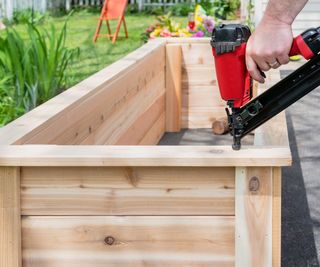 cedar raised garden bed being constructed and fitted together