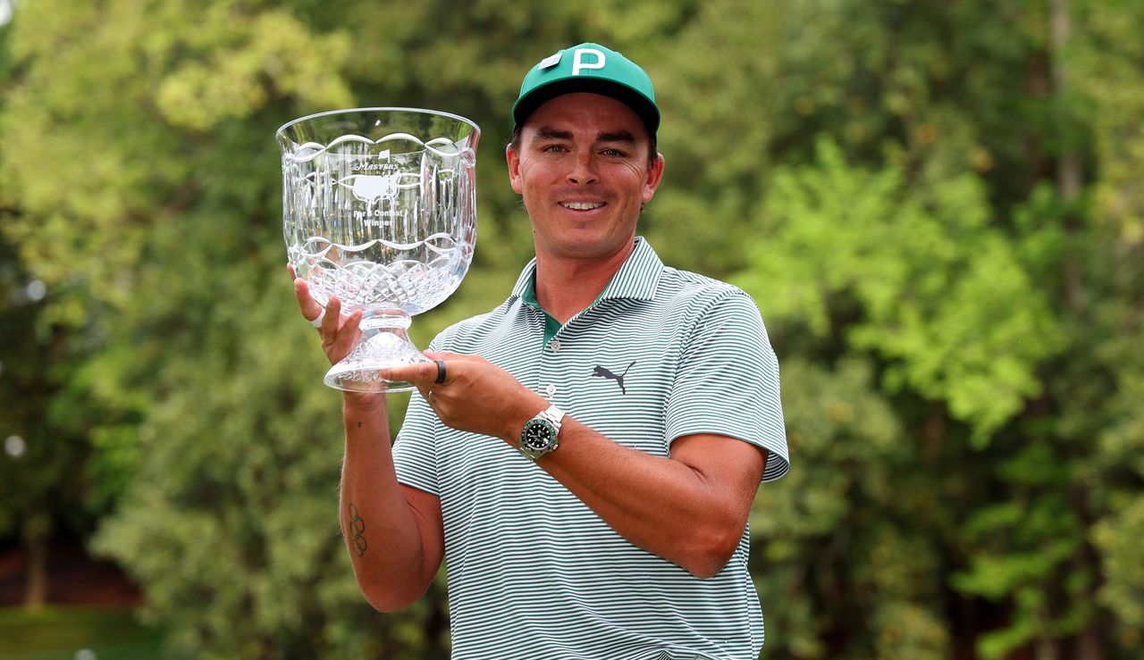 Rickie Fowler holds The Masters par 3 trophy aloft