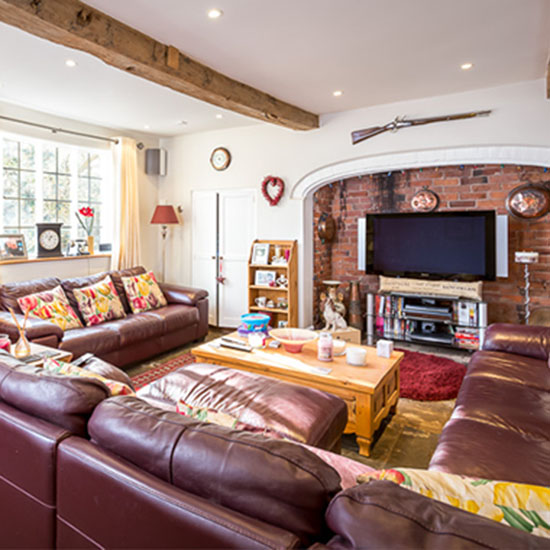 living room with leather sofa and white wall