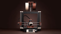 A 3D printer is shown using the new beige and brown 3D printing filaments from Noctua and Prusa Research.