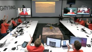 NASA's Mars Helicopter Ingenuity team celebrates after seeing a view of the drone's first flight on Mars captured by the Perseverance rover on April 19, 2021 as they watched from the Jet Propulsion Laboratory in Pasadena, California.