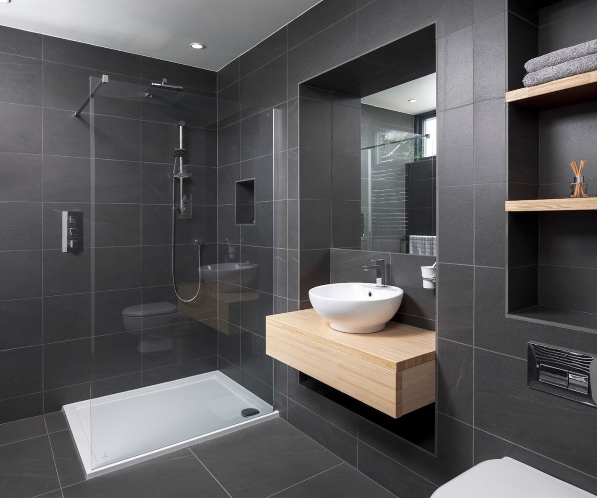 A modern bathroom with black tiles