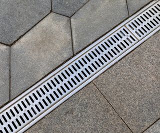 A close up of a trench drain on a patio