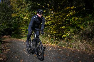 Ribble Allroad Ti Pro being riddwn by a male cyclist on a leafy country lane